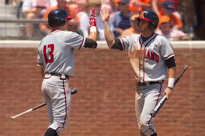 Jun 7, 2014; Charlottesville, VA, USA; Maryland Terrapins outfielder Anthony Papio (13) and shortstop Blake Schmit (1) celebrate a run against the Virginia Cavaliers at Davenport Field.